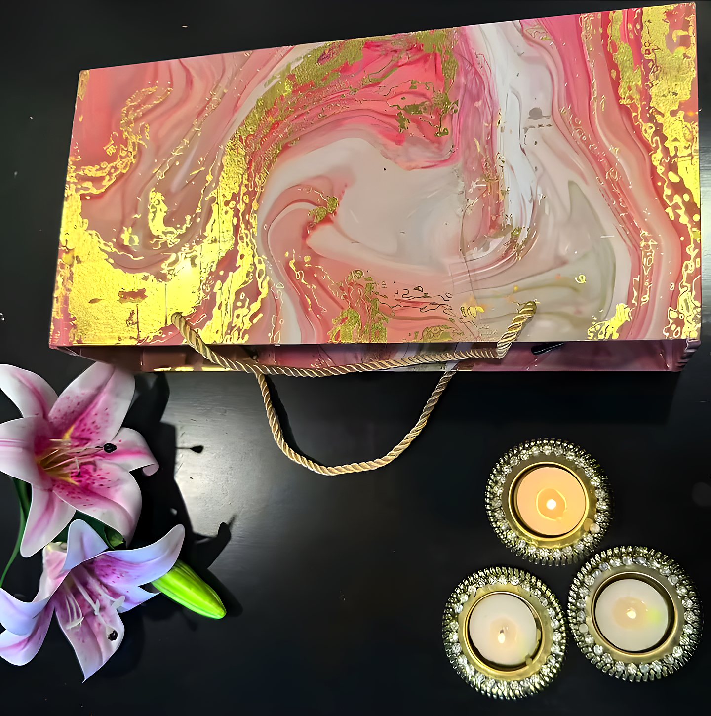 Marble-finish gift box with decorative diyas and lilies